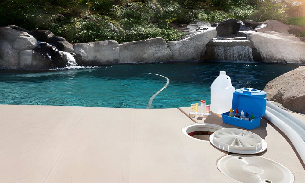 Pool cleaning and maintenance service Jensen Beach professional water testing kit with chemicals beside pool and waterfall feature