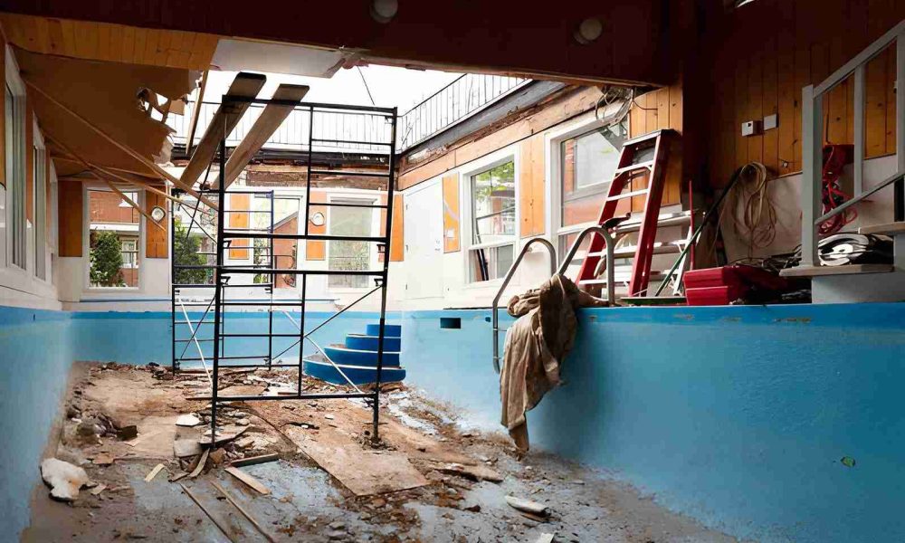 Pool remodeling Hobe Sound indoor renovation with scaffold, broken tiles, and construction materials