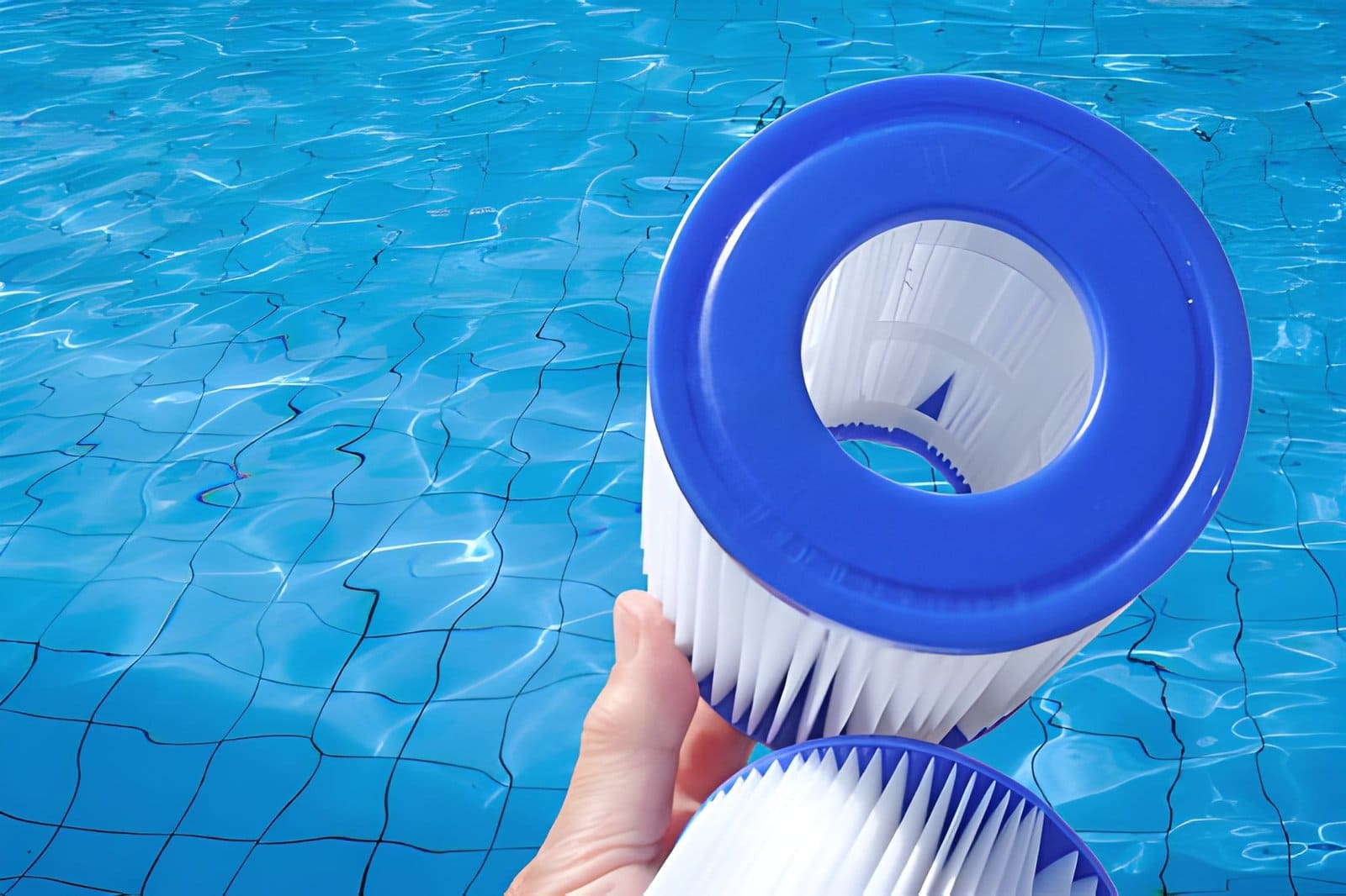 Pool cleaning service Port St Lucie professional holding filter cartridges with clear pool water background